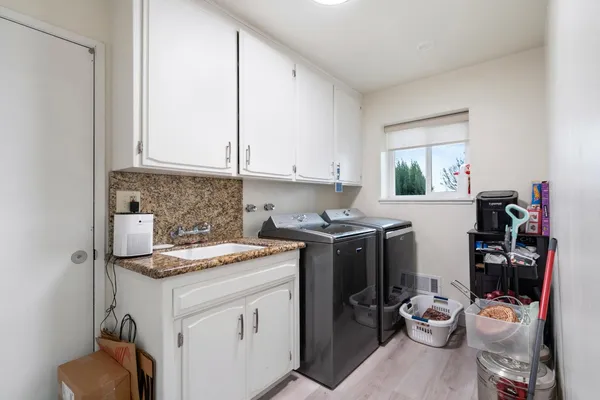 a bedroom with a bed and a painting on the wall