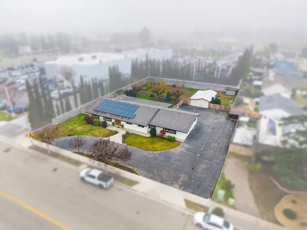 a view of a house with backyard and sitting area