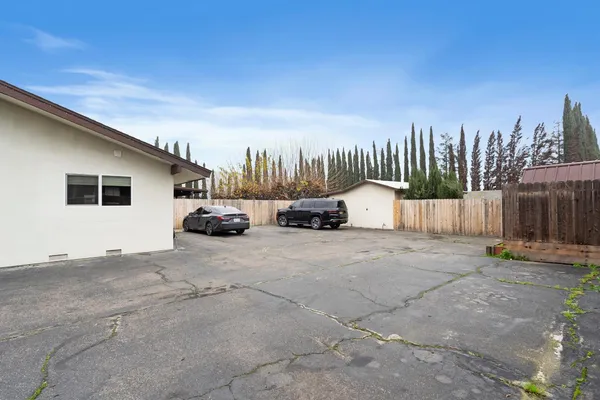 a view of a porch with wooden floor and roof with a garden view