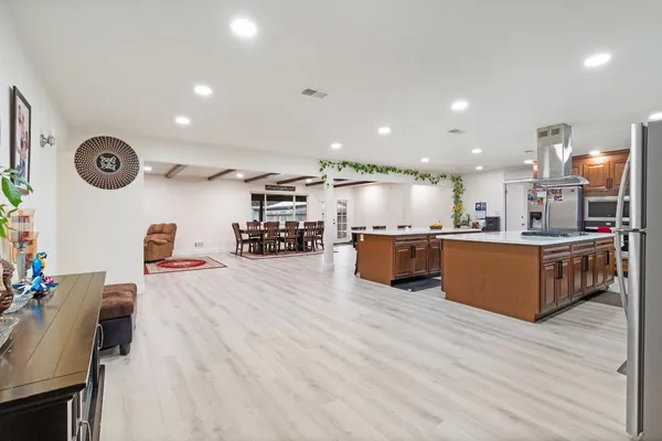 a large kitchen with a table and chairs in it
