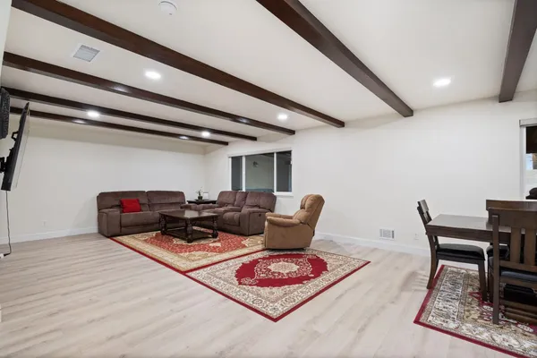 a living room with furniture and wooden floor