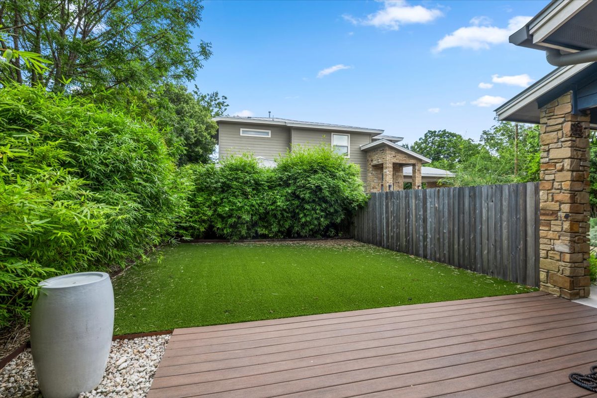 913 Stobaugh Street, Unit B Austin, TX 78757 - Photo 5 of 40 A well-maintained outdoor space with artificial turf and a generous deck offers a private oasis.