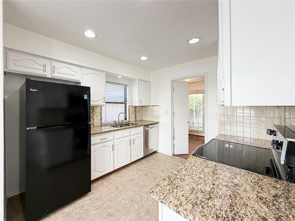 17490 Meandering Way, Unit 1102 Dallas, TX 75252 - Photo 11 of 40 a kitchen with a refrigerator sink and cabinets