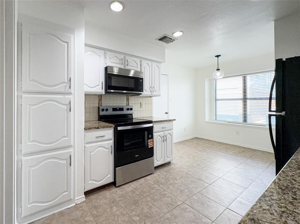 17490 Meandering Way, Unit 1102 Dallas, TX 75252 - Photo 12 of 40 a kitchen with a refrigerator stove and microwave