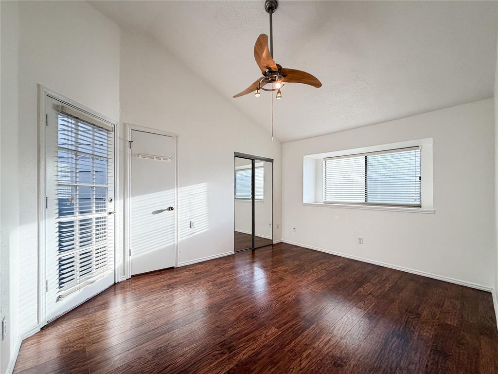 17490 Meandering Way, Unit 1102 Dallas, TX 75252 - Photo 17 of 40 a view of an empty room with wooden floor and windows