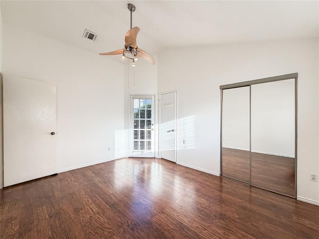 17490 Meandering Way, Unit 1102 Dallas, TX 75252 - Photo 18 of 40 a view of an empty room with wooden floor and a window