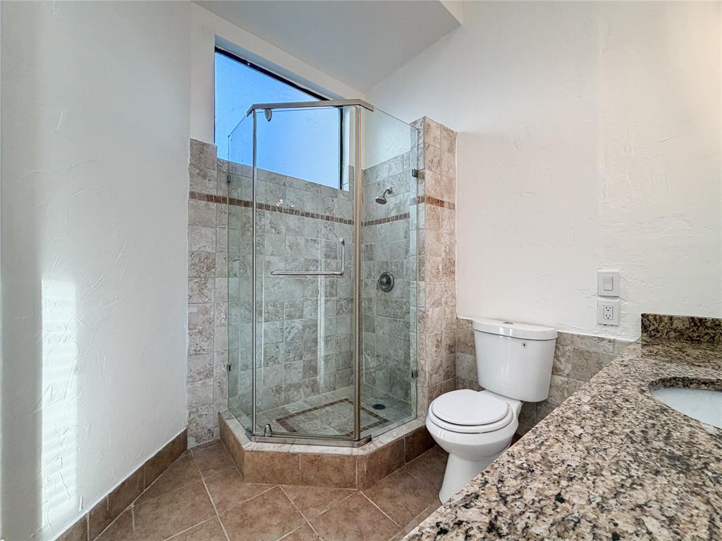 17490 Meandering Way, Unit 1102 Dallas, TX 75252 - Photo 19 of 40 a bathroom with a toilet and a shower