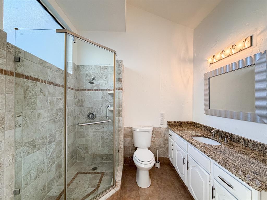 17490 Meandering Way, Unit 1102 Dallas, TX 75252 - Photo 21 of 40 a bathroom with a granite countertop sink toilet and shower