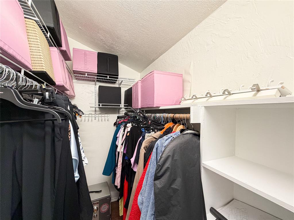 17490 Meandering Way, Unit 1102 Dallas, TX 75252 - Photo 23 of 40 a view of walk in closet with clothes and shoes