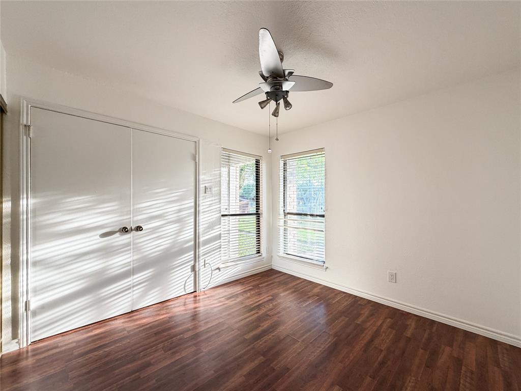 17490 Meandering Way, Unit 1102 Dallas, TX 75252 - Photo 24 of 40 wooden floor in an empty room with a window
