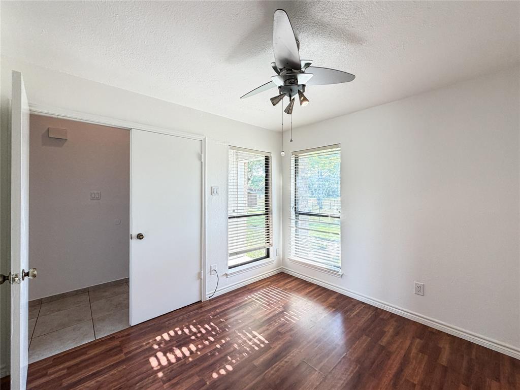 17490 Meandering Way, Unit 1102 Dallas, TX 75252 - Photo 25 of 40 a view of an empty room with a window and wooden floor