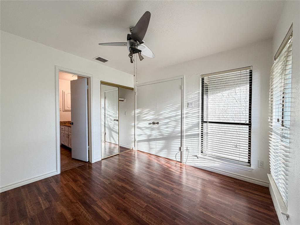 17490 Meandering Way, Unit 1102 Dallas, TX 75252 - Photo 26 of 40 a view of empty room with wooden floor and fan