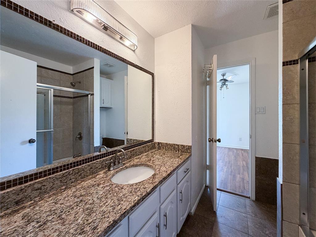 17490 Meandering Way, Unit 1102 Dallas, TX 75252 - Photo 27 of 40 Bathroom featuring vanity, a shower stall, tile floors