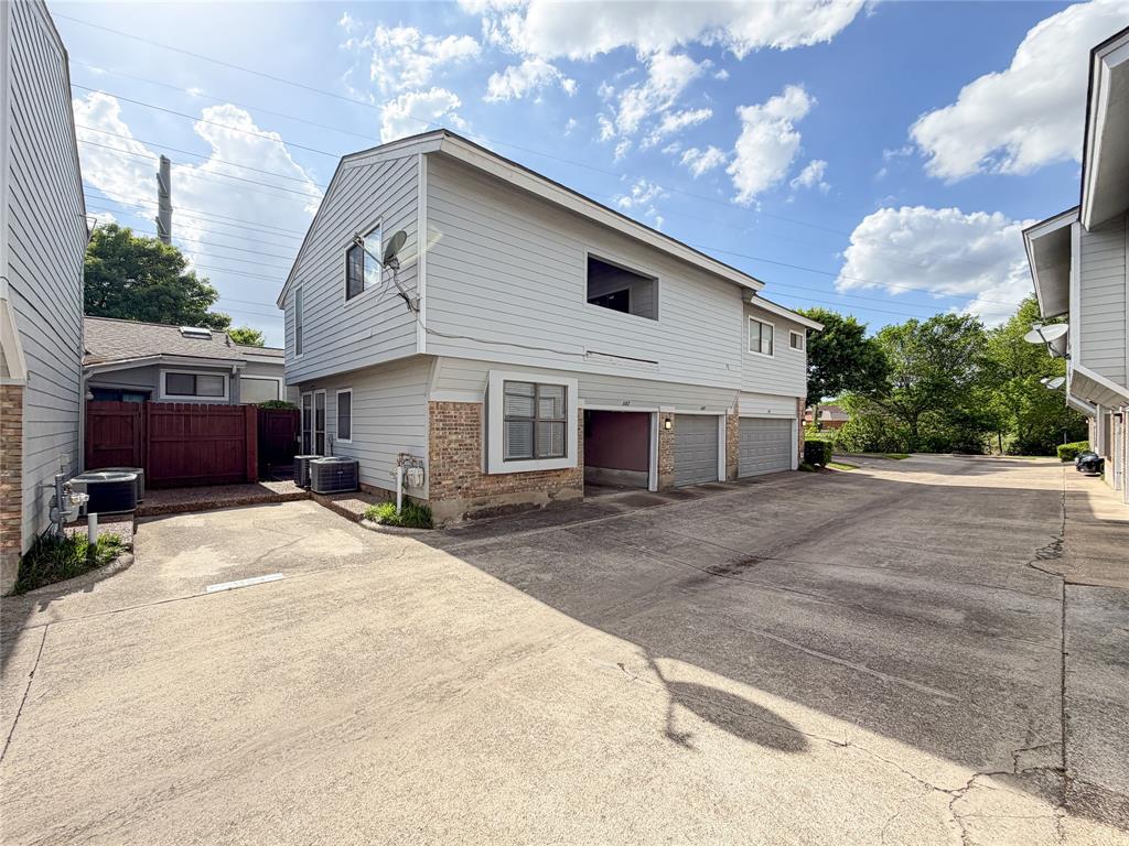 17490 Meandering Way, Unit 1102 Dallas, TX 75252 - Photo 33 of 40 a front view of a house with a yard and garage