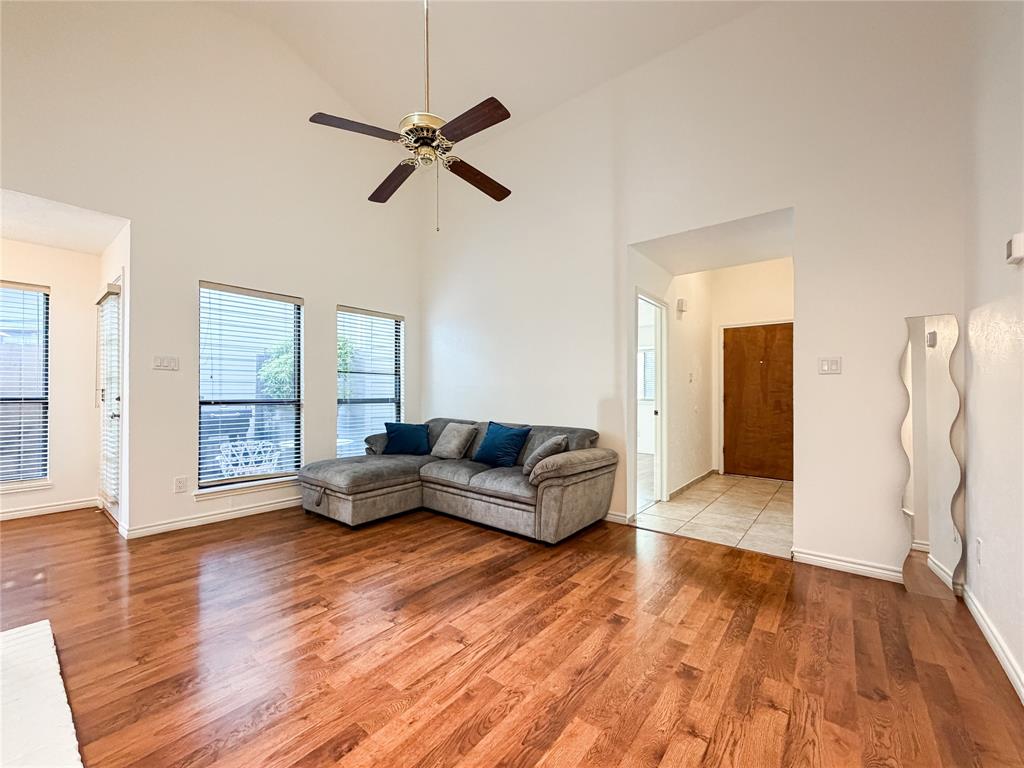 17490 Meandering Way, Unit 1102 Dallas, TX 75252 - Photo 6 of 40 a living room with furniture and a wooden floor