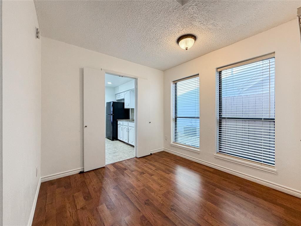 17490 Meandering Way, Unit 1102 Dallas, TX 75252 - Photo 7 of 40 Dining area with laminate flooring and two windows