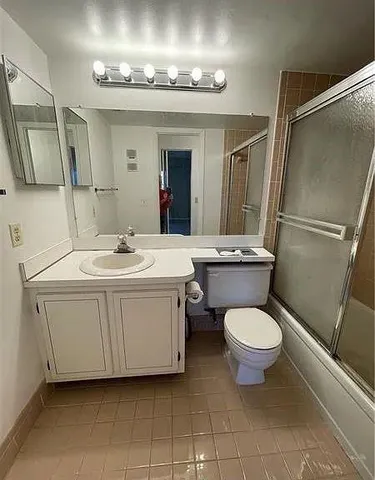 a bathroom with a glass door shower a sink and a mirror