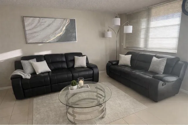 a bed sitting in a bedroom next to a cabinet