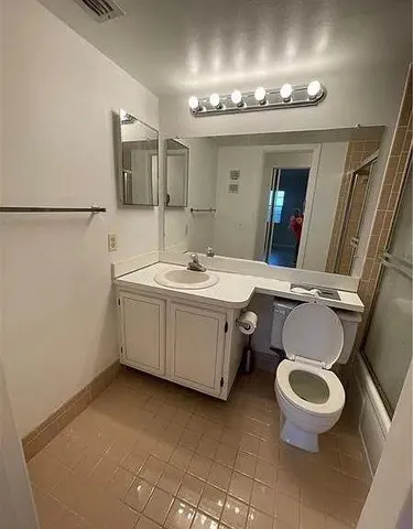 a bathroom with a sink mirror and toilet
