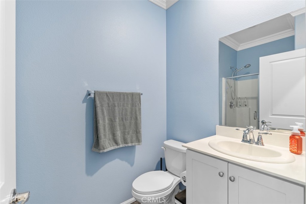 28471 Cosmos Drive Winchester, CA 92596 - Photo 12 of 27 a bathroom with a toilet a sink and mirror