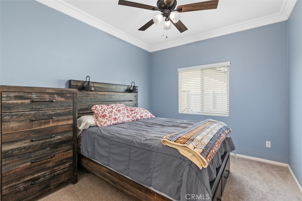 28471 Cosmos Drive Winchester, CA 92596 - Photo 13 of 27 a bedroom with a bed and a chandelier