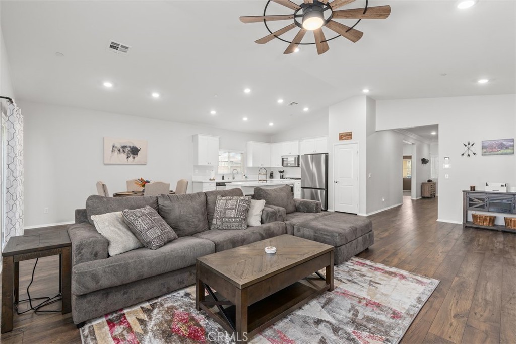 28471 Cosmos Drive Winchester, CA 92596 - Photo 16 of 27 a living room with furniture a wooden floor and chandelier