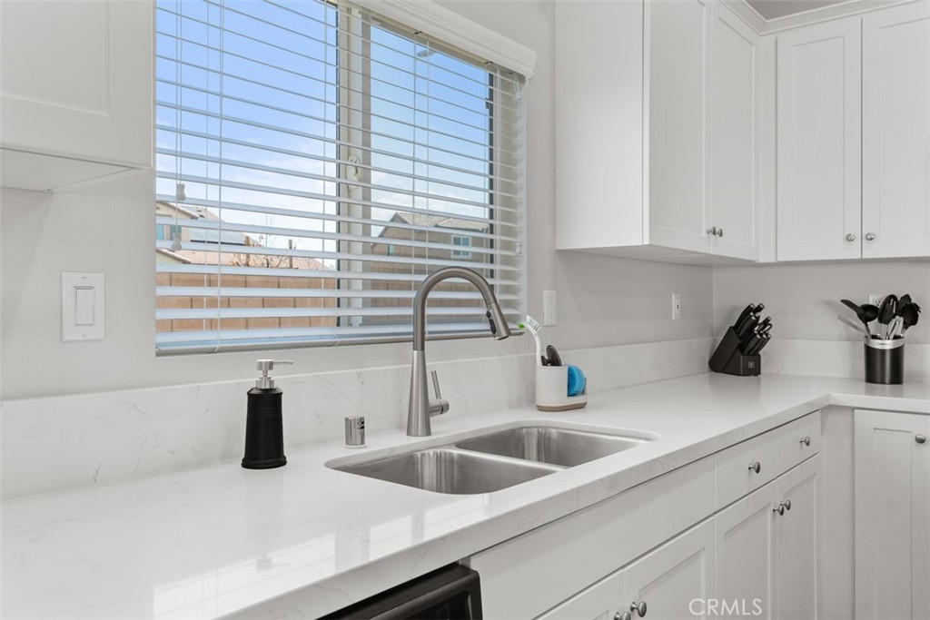 28471 Cosmos Drive Winchester, CA 92596 - Photo 20 of 27 a kitchen with granite countertop a sink and a white wooden cabinets