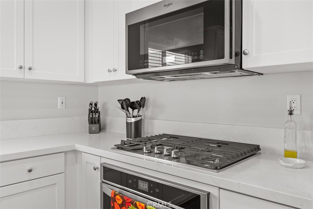 28471 Cosmos Drive Winchester, CA 92596 - Photo 21 of 27 a stove top oven sitting inside of a kitchen