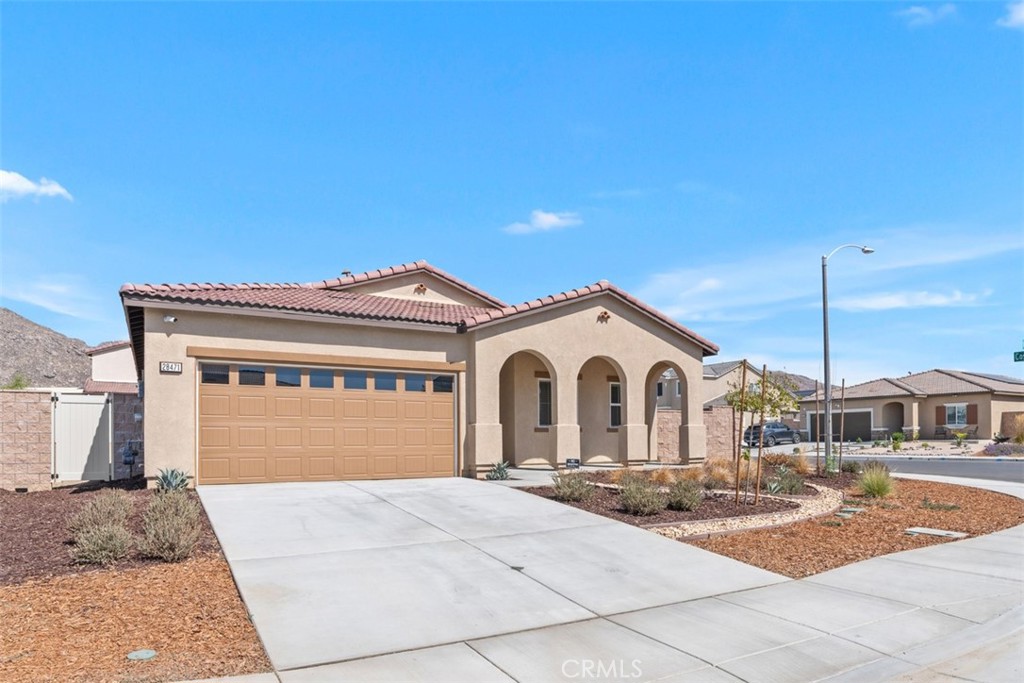28471 Cosmos Drive Winchester, CA 92596 - Photo 3 of 27 a front view of a house with a yard and garage