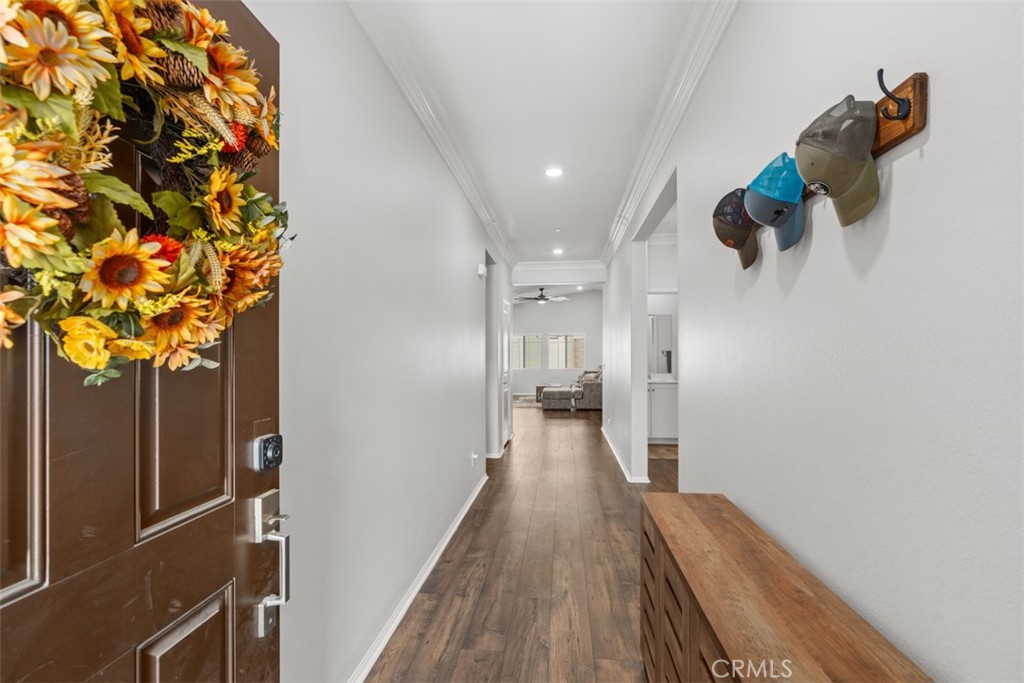28471 Cosmos Drive Winchester, CA 92596 - Photo 7 of 27 a view of a hallway with wooden floor and staircase