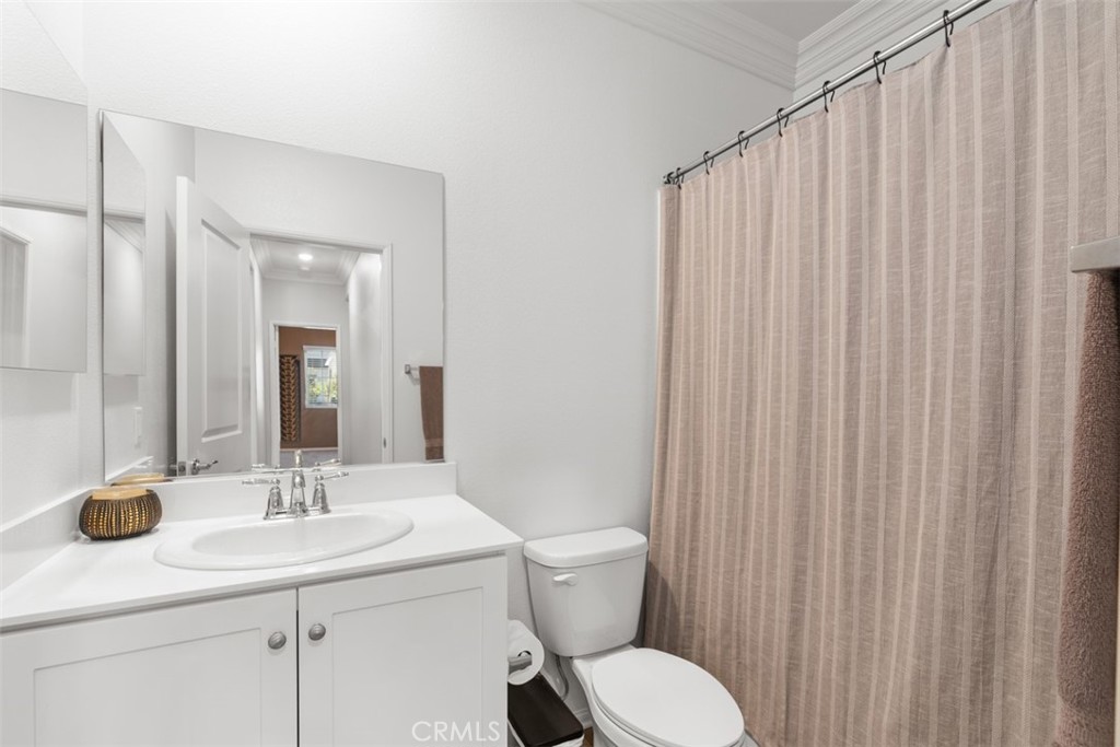 28471 Cosmos Drive Winchester, CA 92596 - Photo 10 of 27 a bathroom with a toilet a sink and mirror