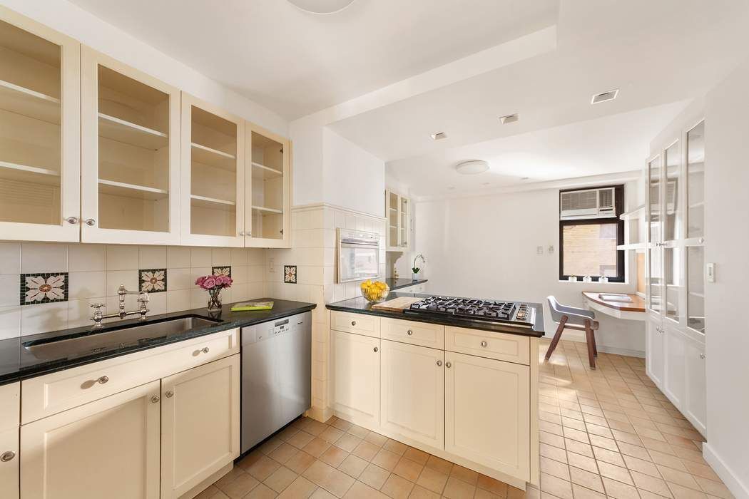 47 East 88th Street, Unit 8A Manhattan, NY 10128 - Photo 10 of 27 a kitchen with a sink and cabinets