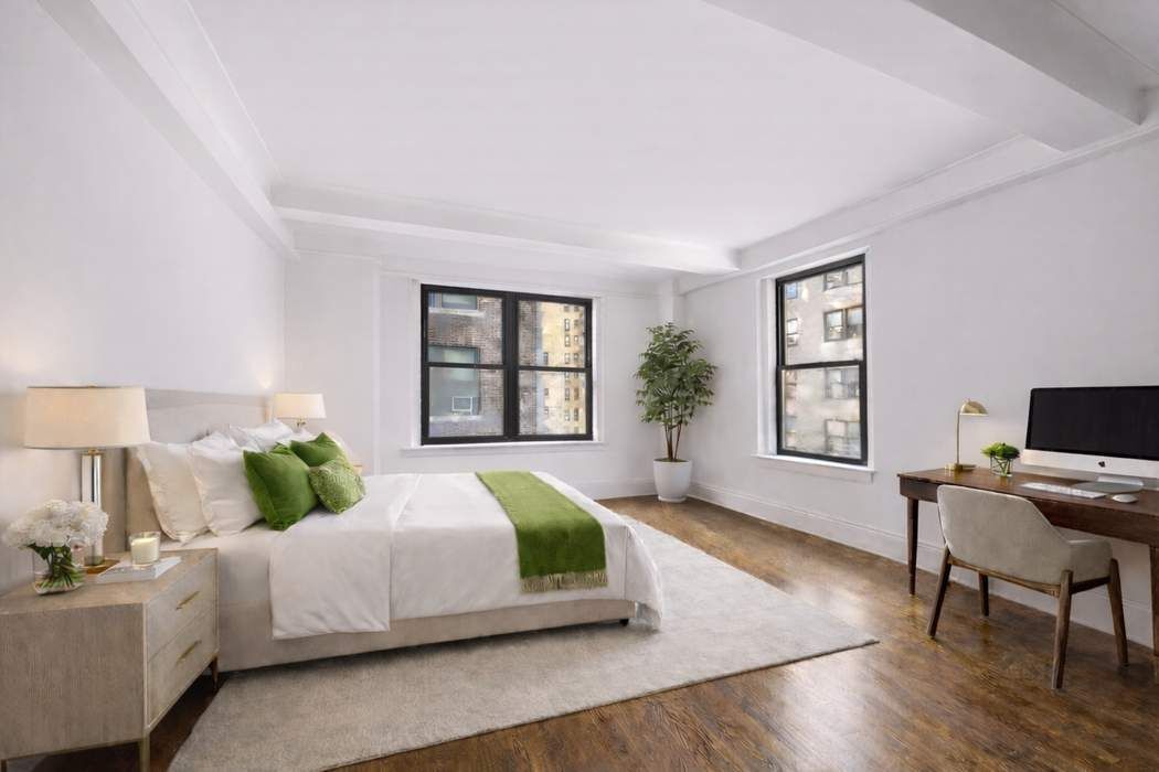 47 East 88th Street, Unit 8A Manhattan, NY 10128 - Photo 16 of 27 a bedroom with a bed a table and chair