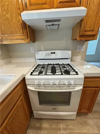 a stove top oven sitting inside of a kitchen