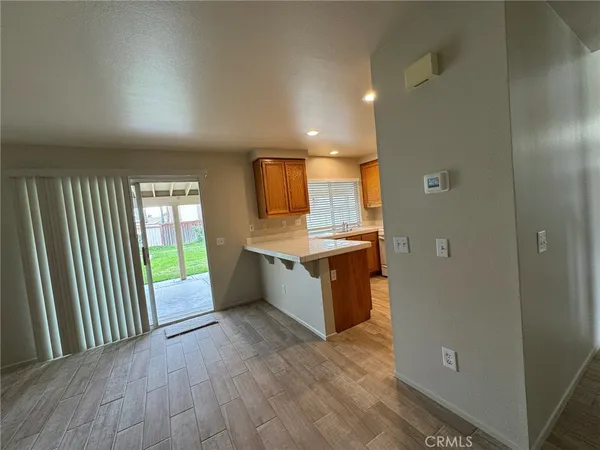 a large kitchen with a large counter top a sink and stainless steel appliances