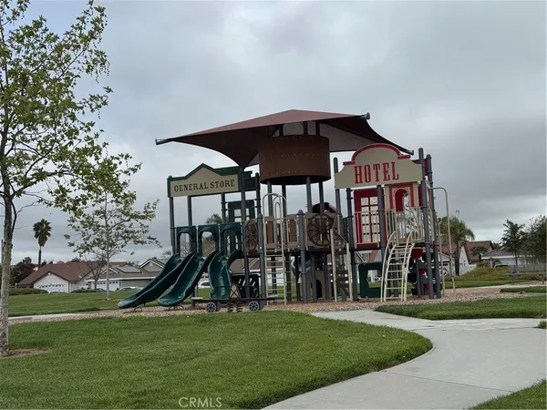 a view of a park with swings and slides