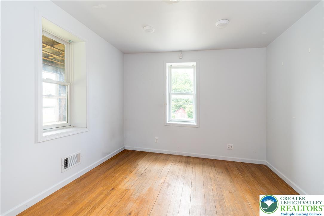 1815 Leithsville Road Hellertown, PA 18055 - Photo 9 of 38 Well-lit room features bright walls and polished hardwood floors, offering a tranquil space.