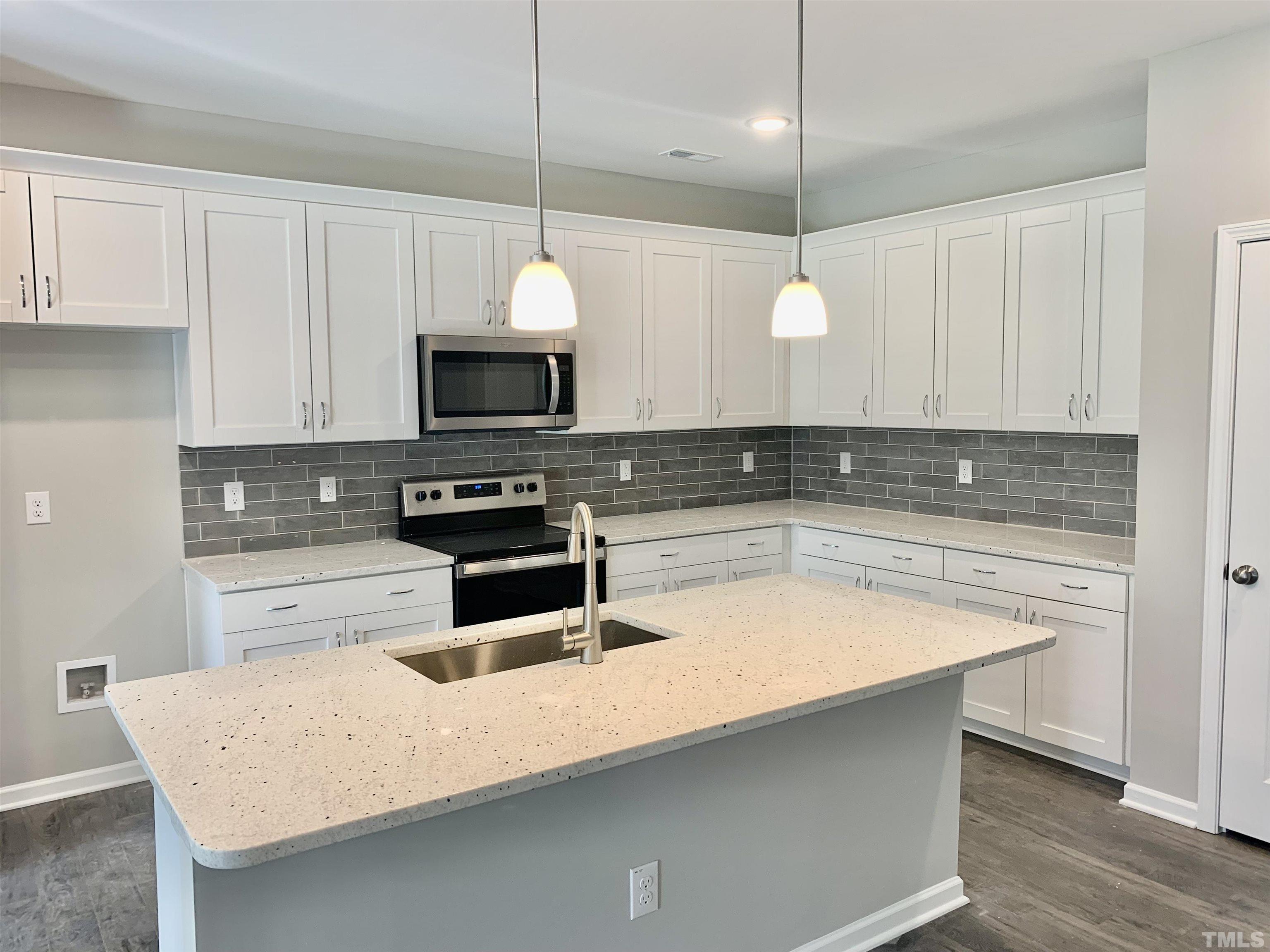 106 Two Daughters Streme Smithfield, NC 27577 - Photo 2 of 14 a kitchen with a appliances a stove a microwave and cabinets