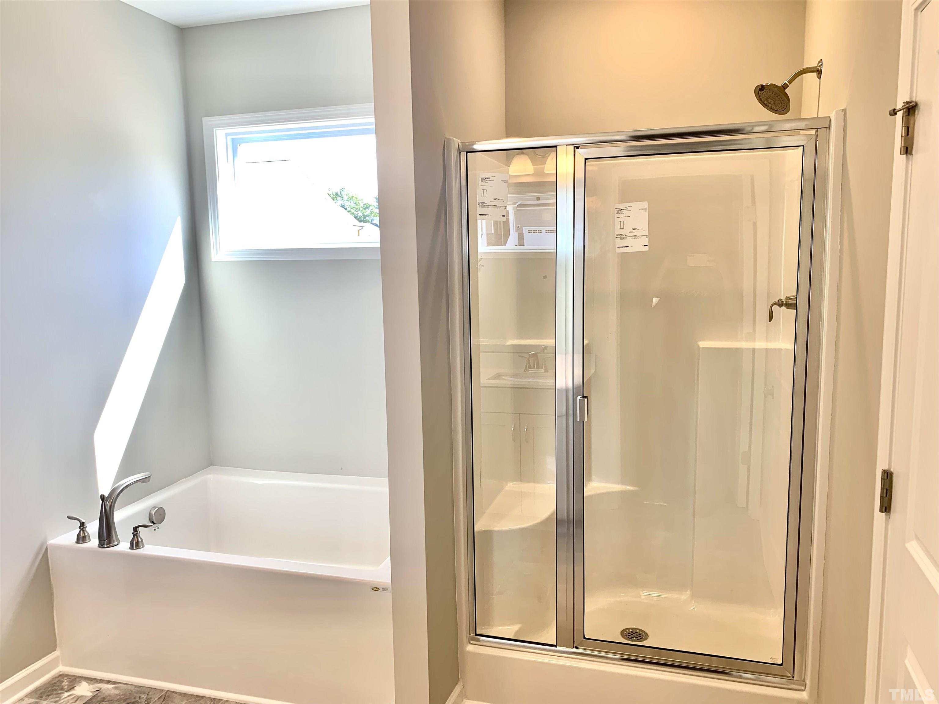 106 Two Daughters Streme Smithfield, NC 27577 - Photo 5 of 14 a bathroom with a bathtub and a shower