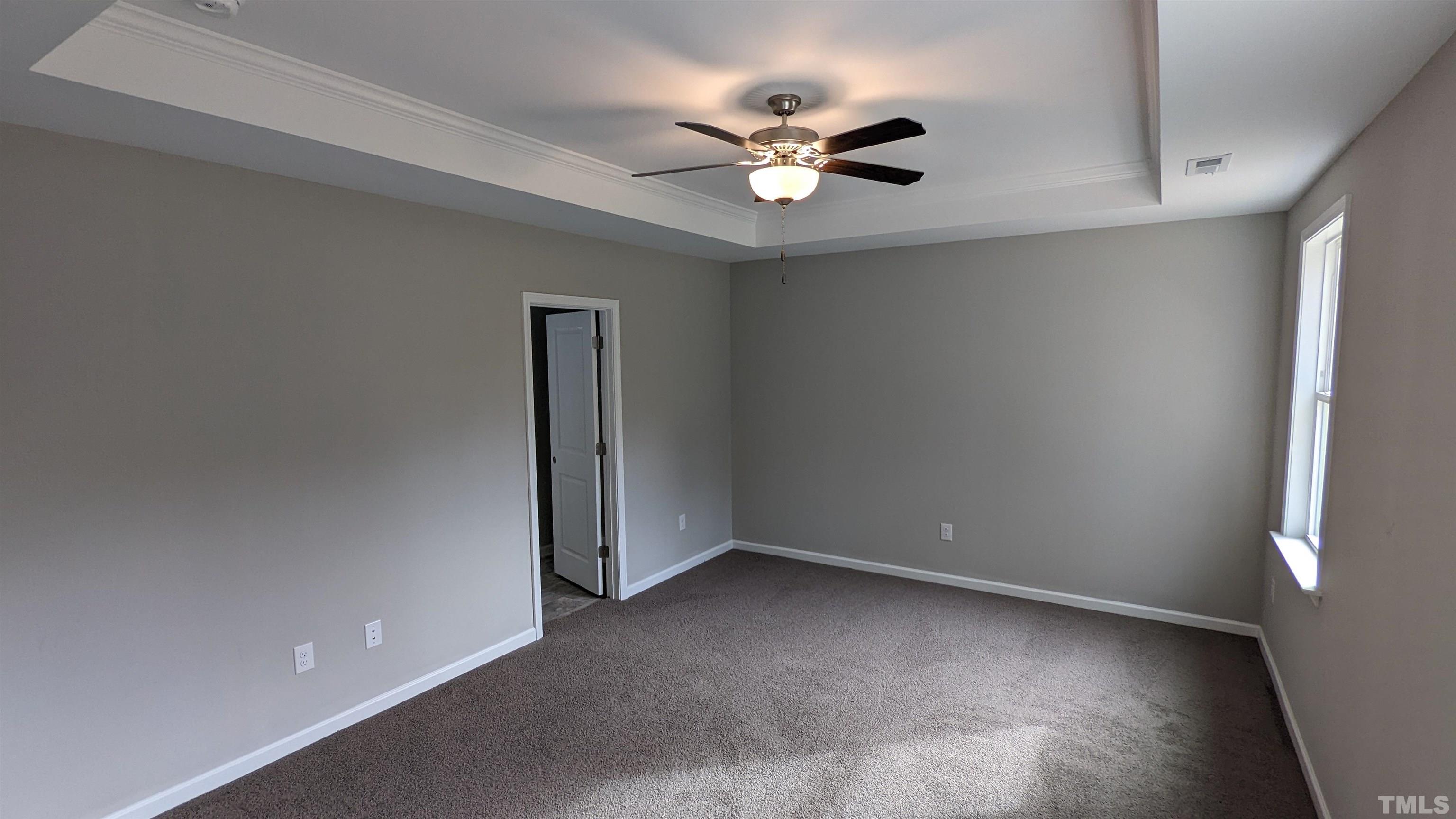 106 Two Daughters Streme Smithfield, NC 27577 - Photo 8 of 14 a view of an empty room with a ceiling fan