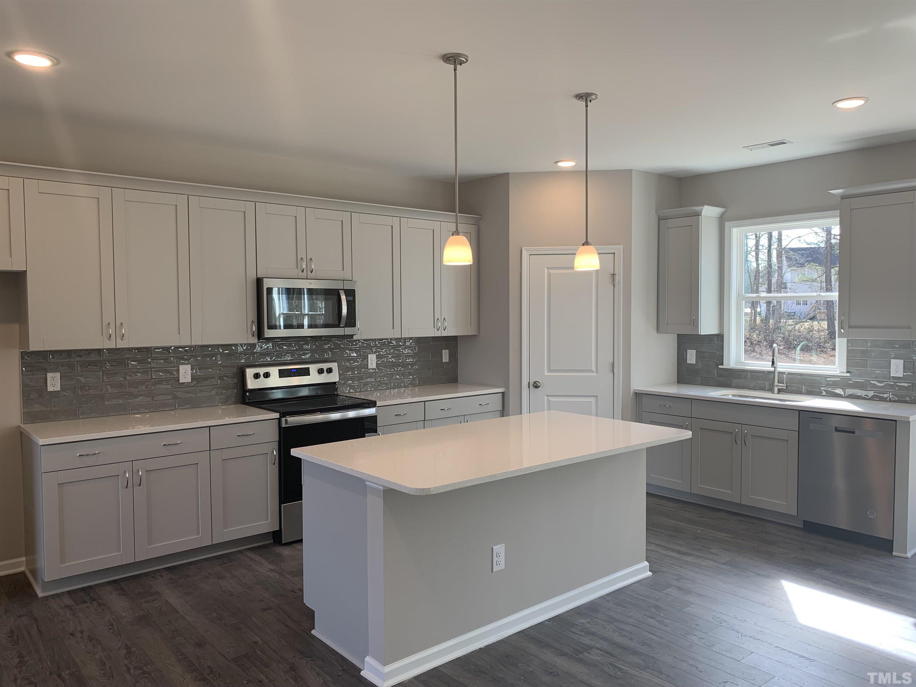 106 Two Daughters Streme Smithfield, NC 27577 - Photo 10 of 14 a kitchen with kitchen island a sink stove and microwave