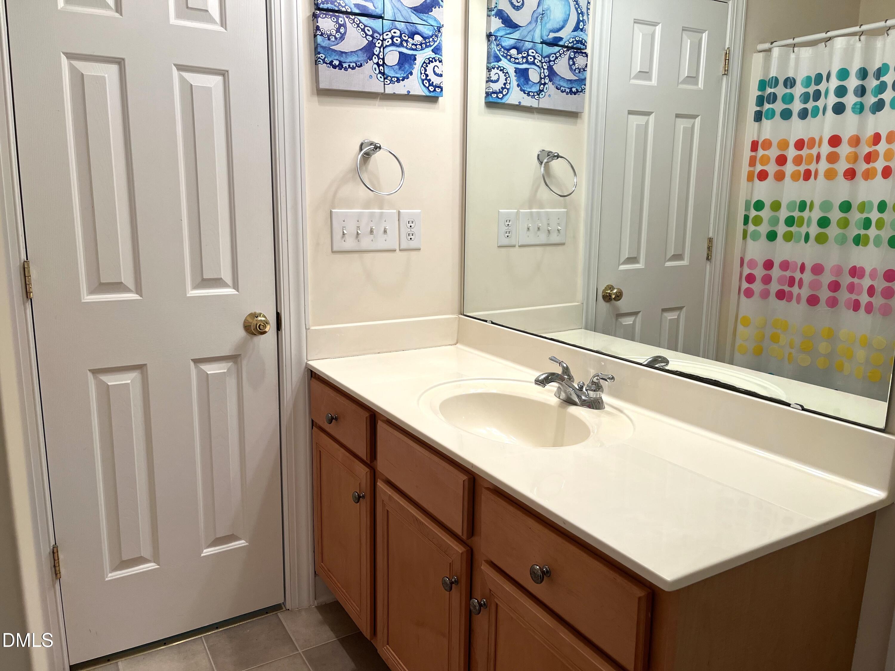 5206 Rio Grande Drive Raleigh, NC 27616 - Photo 27 of 37 a bathroom with a sink and a mirror