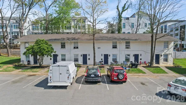 a couple of cars parked in front of a house
