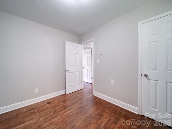 a view of an empty room and wooden floor