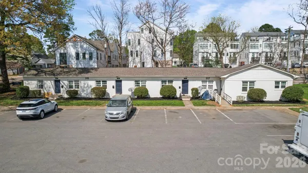 a car parked in front of a white building