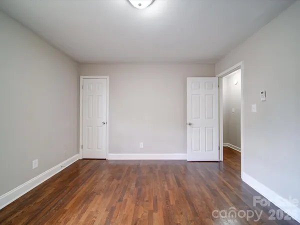 a view of an empty room and wooden floor