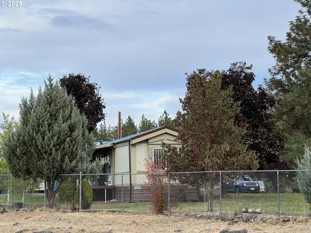 a view of house with trees in the background