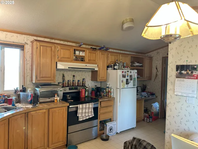 a kitchen with refrigerator and cabinets