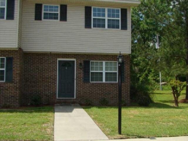 a front view of a house with a yard