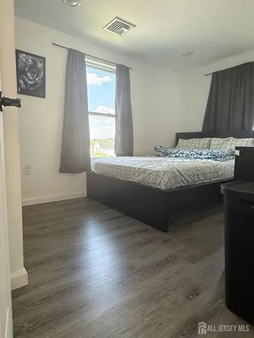 a bedroom with a bed and a dresser